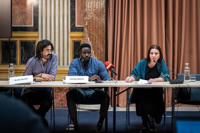 A panel discussion at a table with microphones