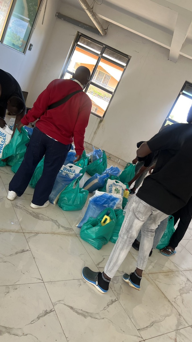 Volunteers sorting and packing supplies in a room