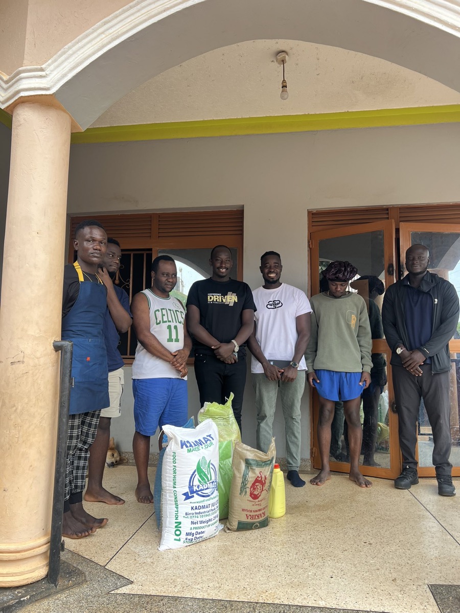 A group beside sacks of food supplies at a distribution