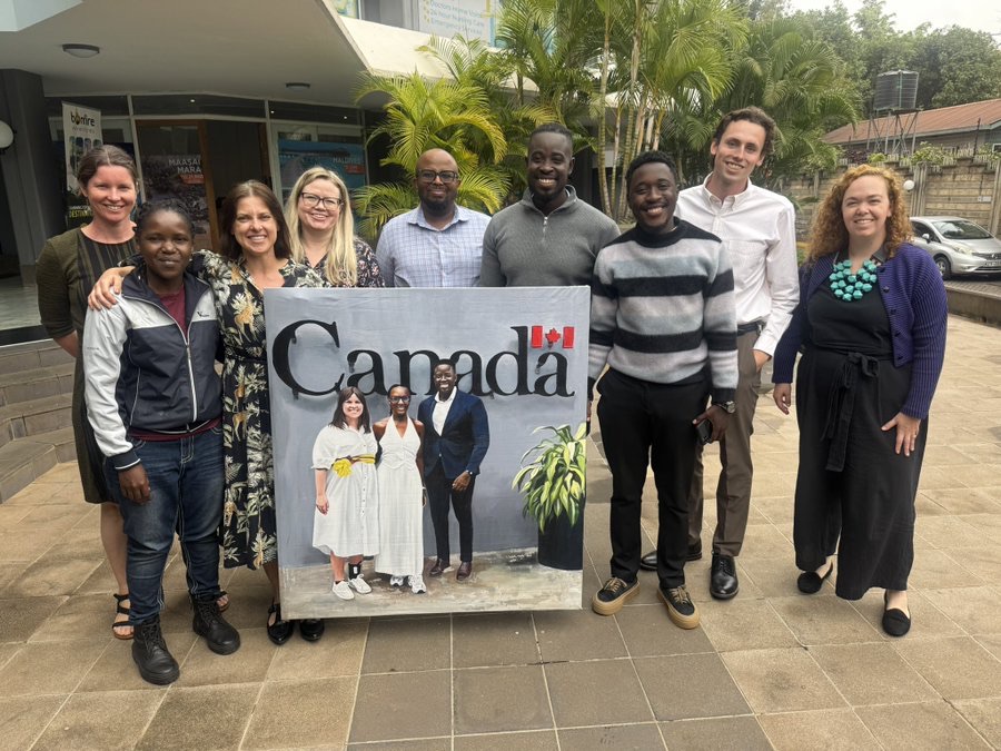 A group with a painting at a Canadian event