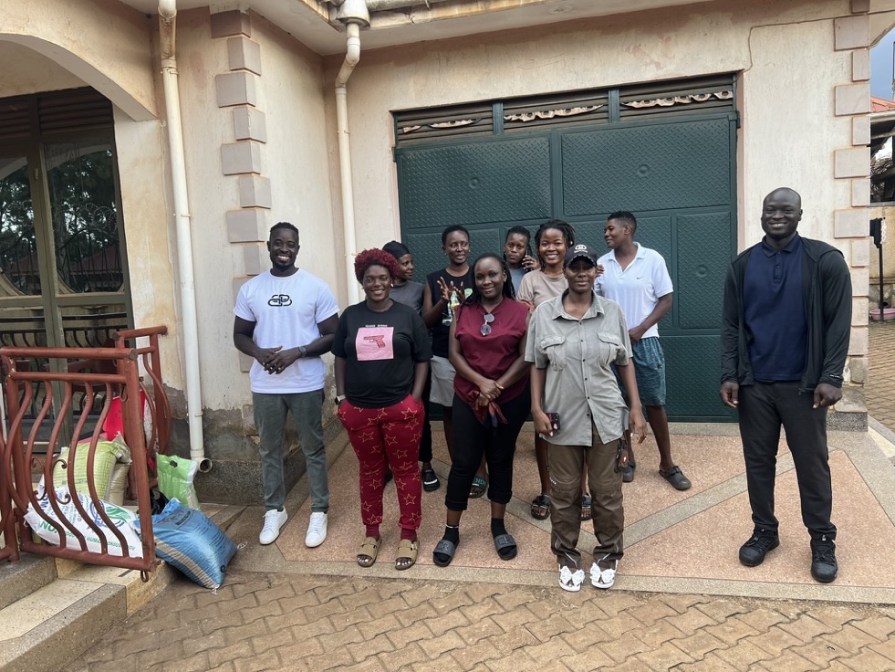 A group gathered outside a compound gate
