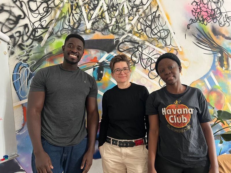 Friends in front of a mural